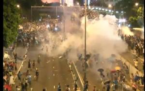 The Hong Kong police fires tear gas at unarmed protestors.